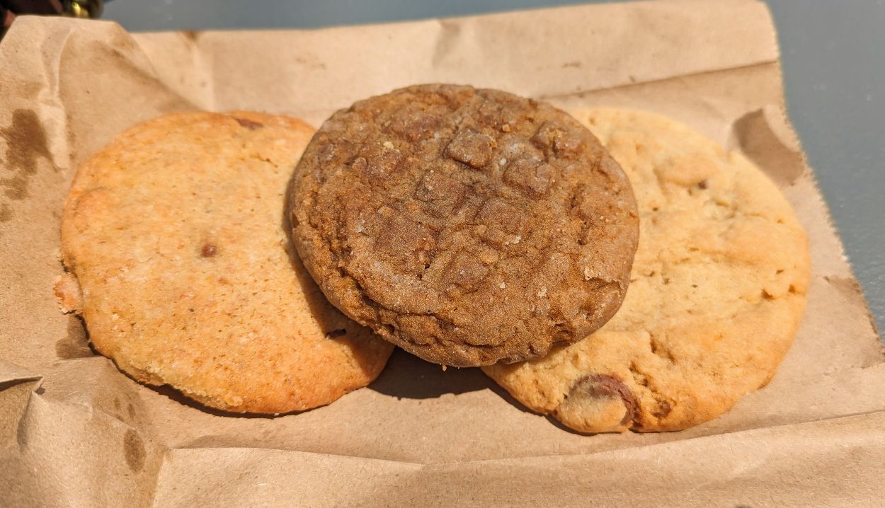 Three cookies on a brown paper bag from Perth, ON farmers market.